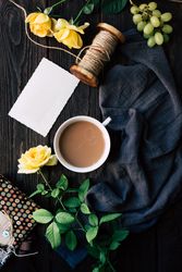 Flowers and empty note near coffee