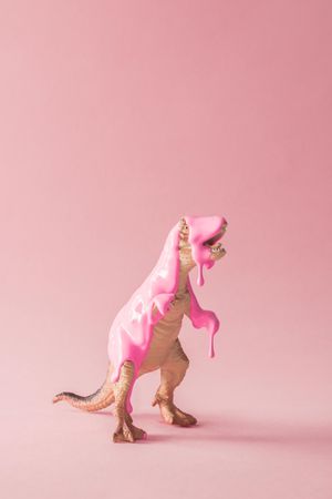 Pink paint dripping on dinosaur toy