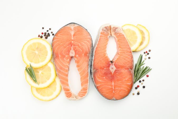 Fresh raw salmon meat and spices isolated on light background