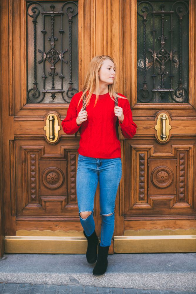 Confident woman near ornamental wall