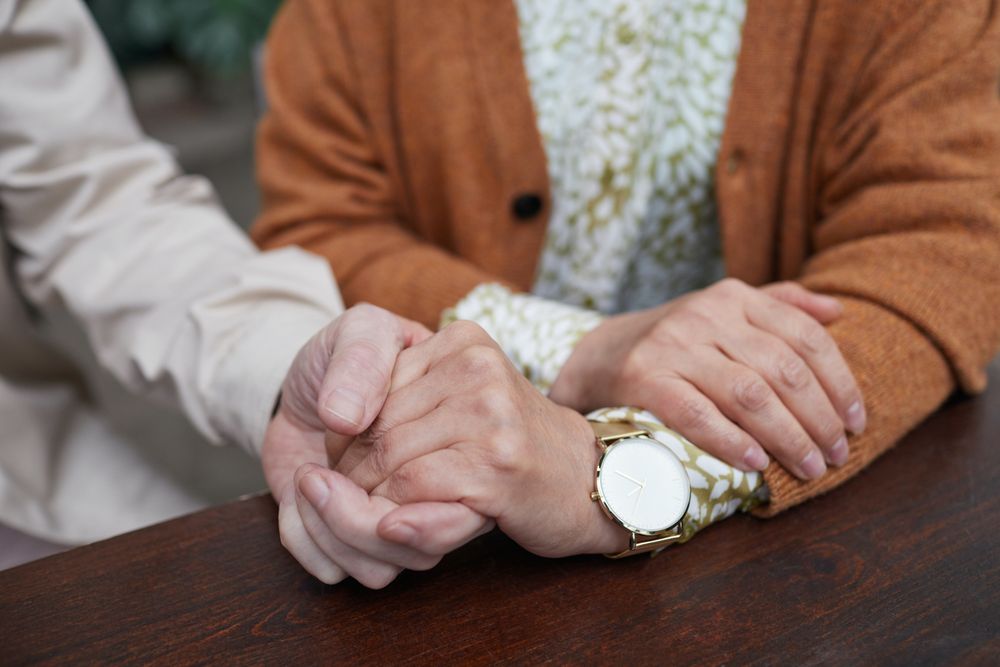 Cropped image of a person comforting another person