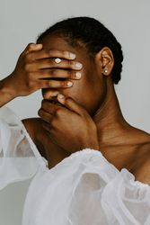 Woman covering her face with both hands