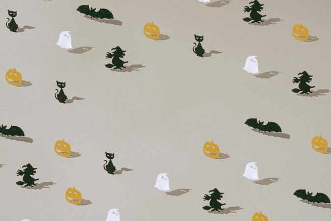Halloween minimal pattern with paper ghost, pumpkin, witch, bat and car, with copy space