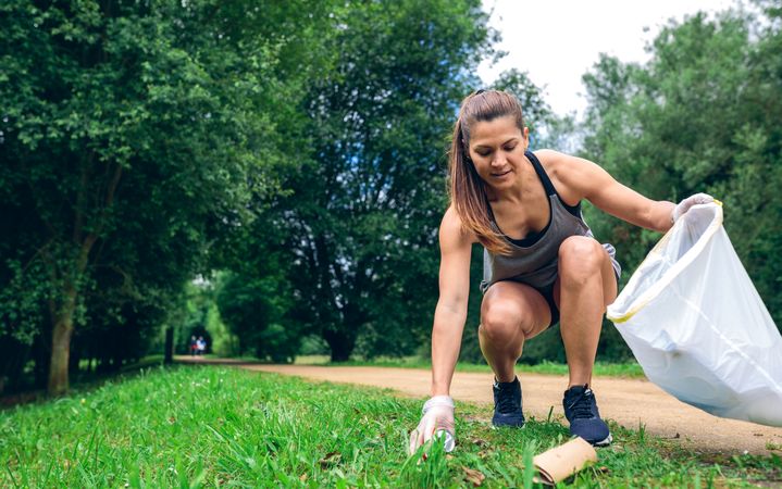 Woman with garbage bag doing plogging
