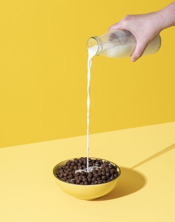 Pouring milk into the cereal bowl