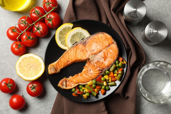 Composition with tasty grilled salmon on gray background, top view