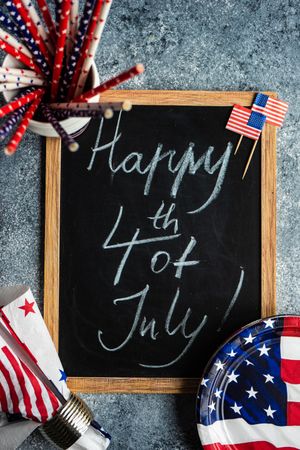 Chalkboard surrounded by flags with the words "Happy 4th of July"