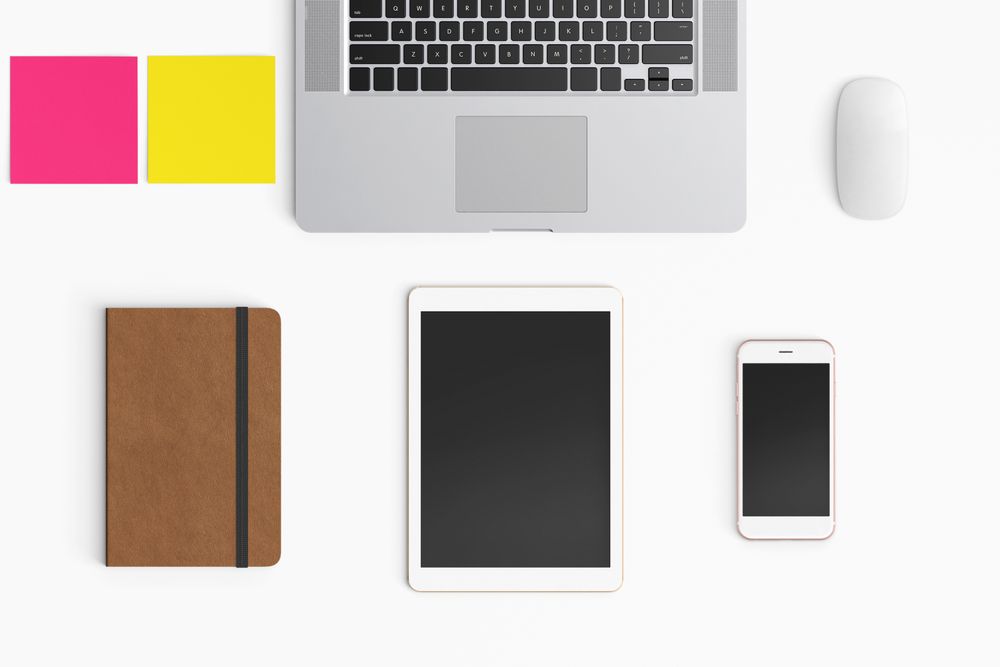 Modern workspace with coffee cup, smartphone, paper, notebook, tablet and laptop