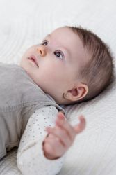 Happy baby girl lying on back