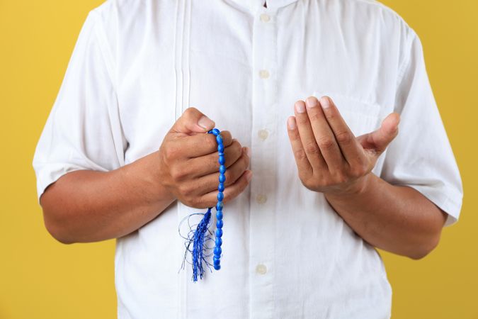 Hands of Muslim Old Man with Prayer Beads