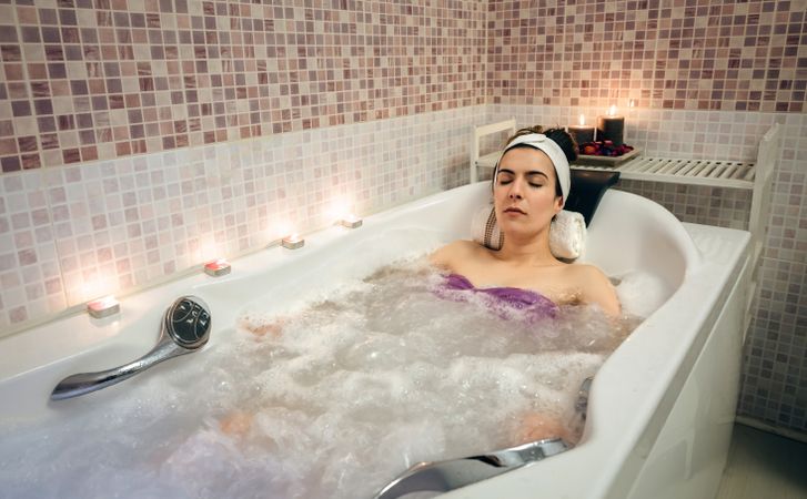 Woman resting in jaccuzi bath in spa