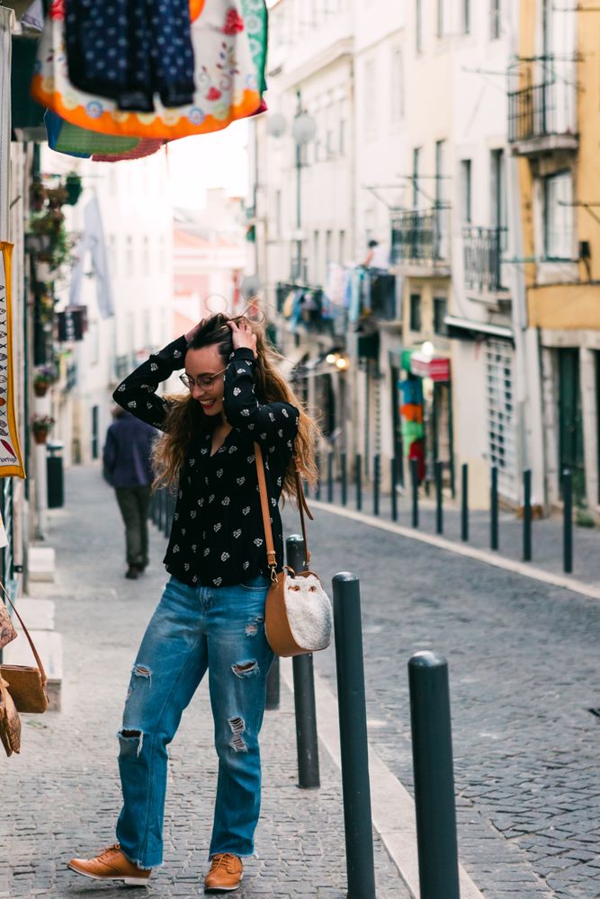 woman exploring street stall with clothes