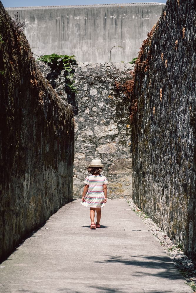 Girl in narrow stone walkway