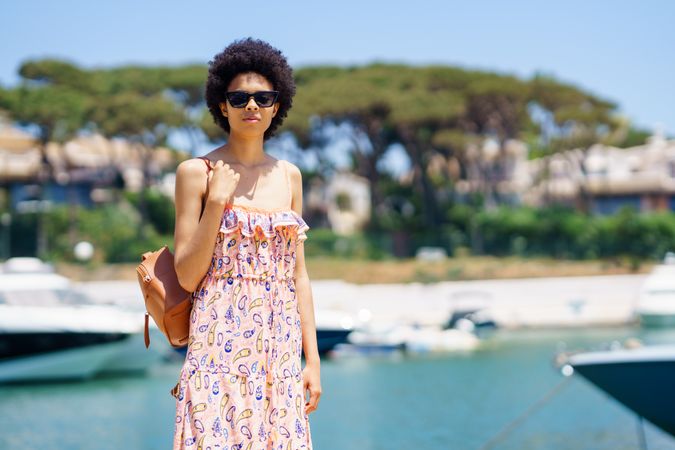 Female in maxi dress standing on dock on sunny day