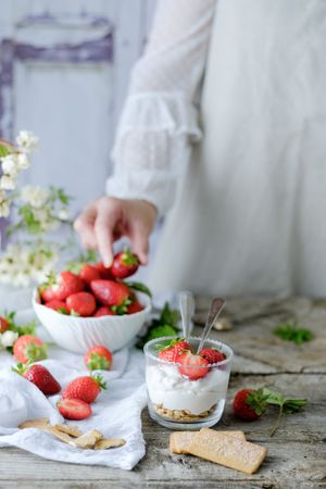 Confectioner cooking dessert of ripe strawberries