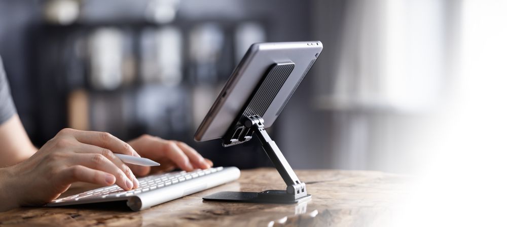 Man working on tablet with keyboard