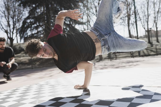 Man dancing break dance in park