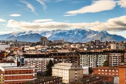 Modern buildings in city near mountains