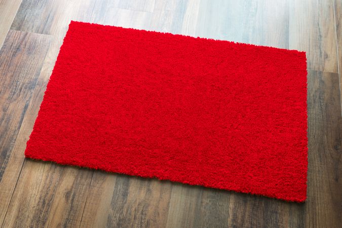 Blank Red Welcome Mat On Wood Floor Background Ready For Your Own Text