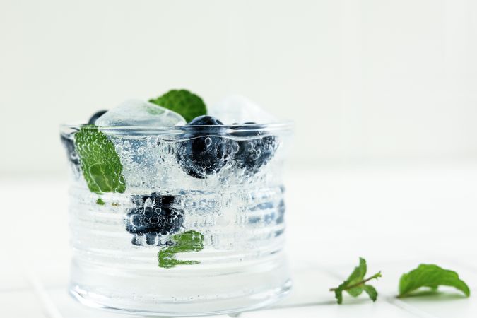 Fresh carbonated drink with blueberries and mint garnish