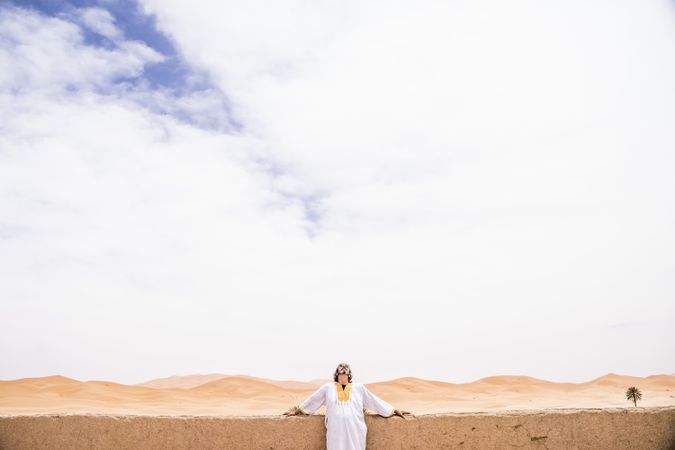 Cheerful adult man in desert