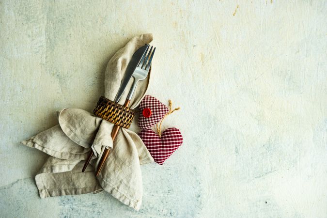 St. Valentine's Day card with cutlery wrapped in napkin with felt heart decorations