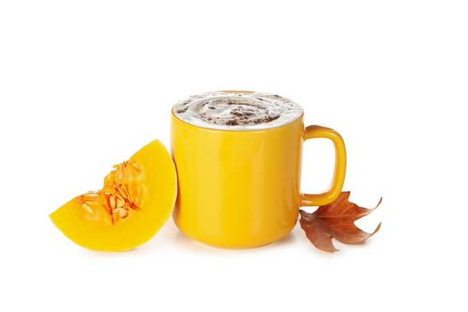 Composition with cup of pumpkin latte isolated on blank background