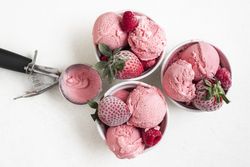 Ice cream and frozen berries on table