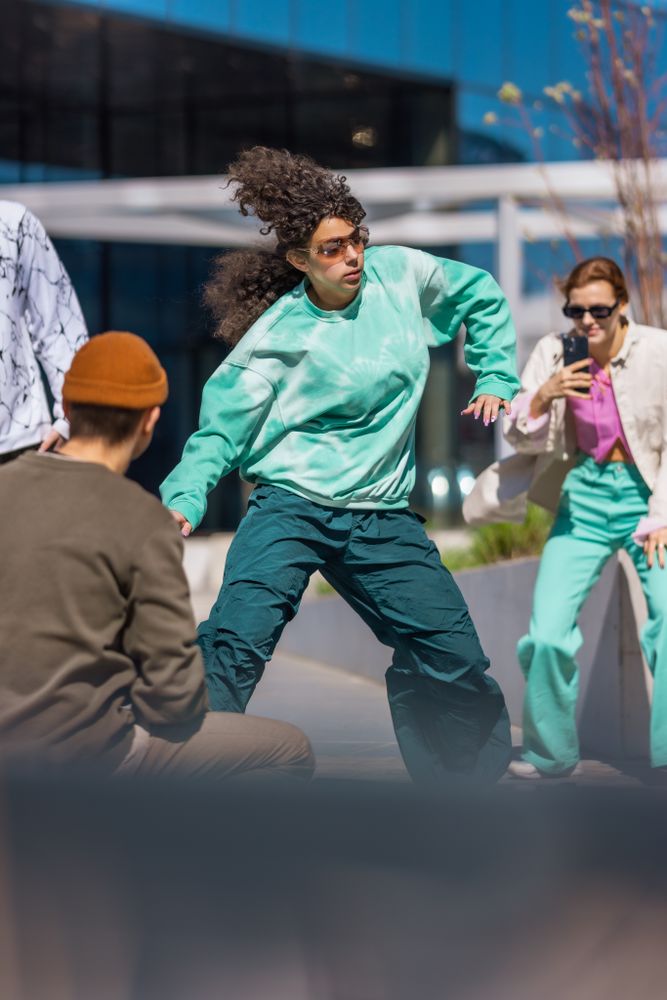 Female Hip-Hop Dancer Practicing Choreography While Crowd Of Creative People Filming Her On Smartphone For Social Media