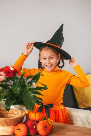 Little Girl Playing With a Pumpkin.