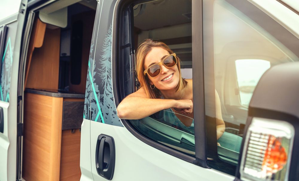 Female passenger in motorhome leaning out window