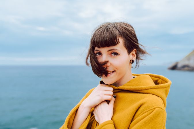 Young woman standing near sea