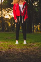 Crop sportive woman standing on meadow