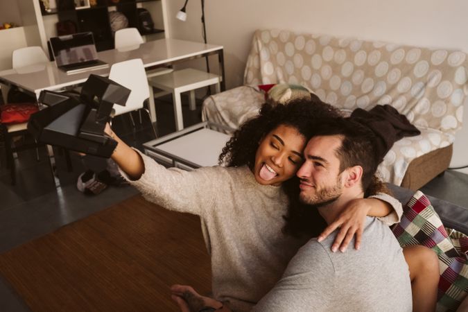 Couple taking selfie on couch
