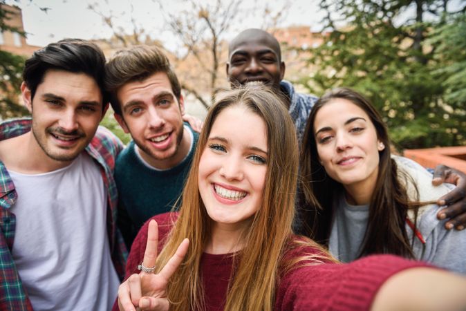 Happy group of friends looking at camera and smiling for picture