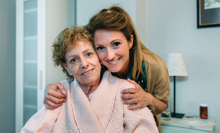 Affectionate caretaker posing with patient