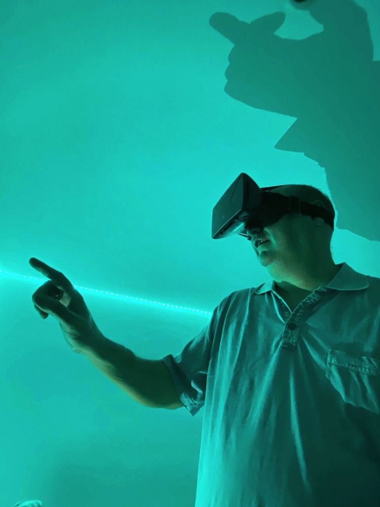 Man wearing virtual reality headset in green lit room