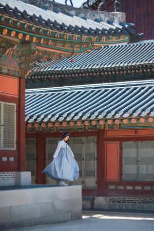Young woman in hanbok standing in Gyeongbokgung palace in Seoul, South Korea