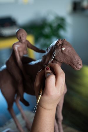 Close up of clay sculpture of horse and rider