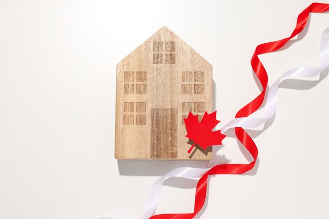 Wooden house with maple leaf and ribbons