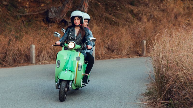 Young people riding motorcycles on city road