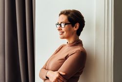 Happy female wearing eyeglasses looking away