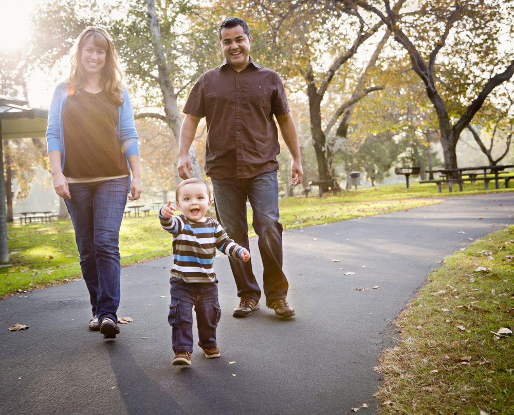 Happy Family Walking In The Park