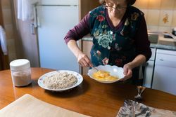 Mature woman beating eggs to coat the croquettes