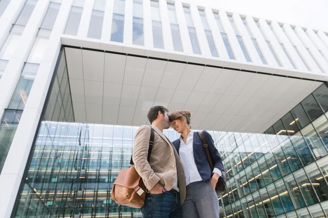 Businesspeople couple outside contemporary building
