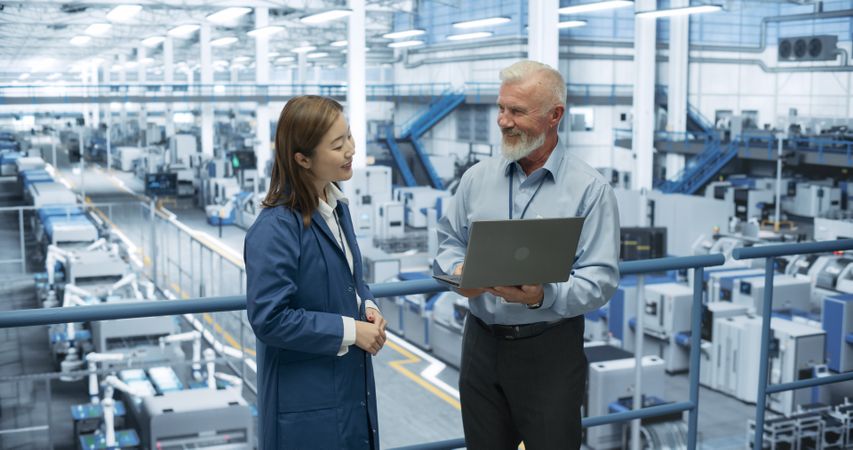 Experienced Mature Engineer Giving an Electronics Factory Tour to Young Japanese Student. Asian Female with Technical Background Asking Questions About Production, Manufacturing, Research