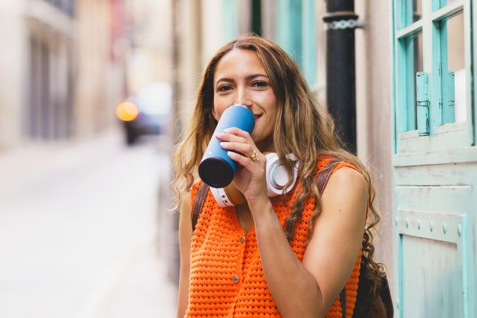 Woman drinking water from reusable water bottle