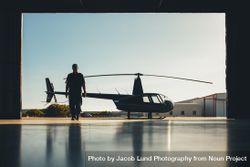 Silhouette of helicopter with a pilot in the airplane hangar 0K6Vyb