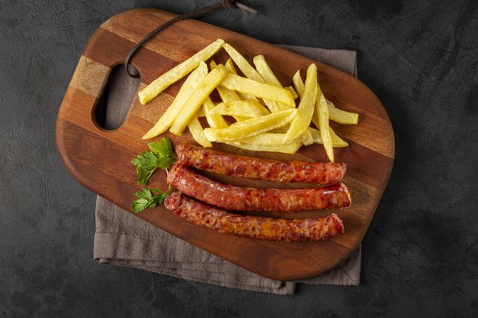 Grilled German sausage with french fries.
