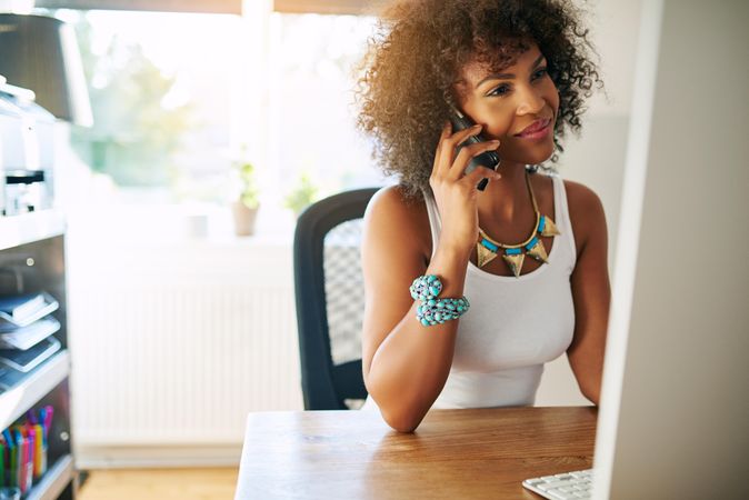 Black female working in home office making a phone call